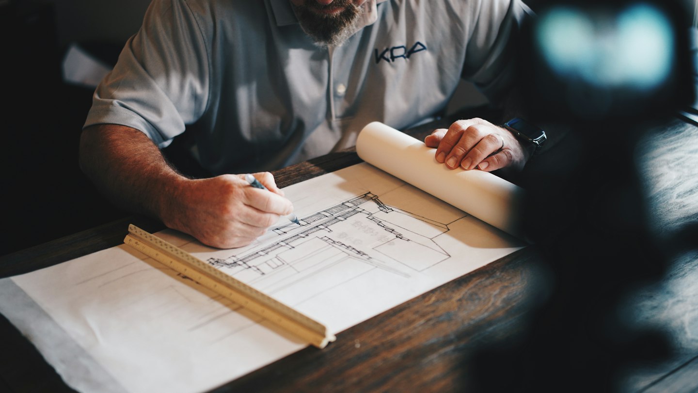 Architectural plans and tools on a worktable