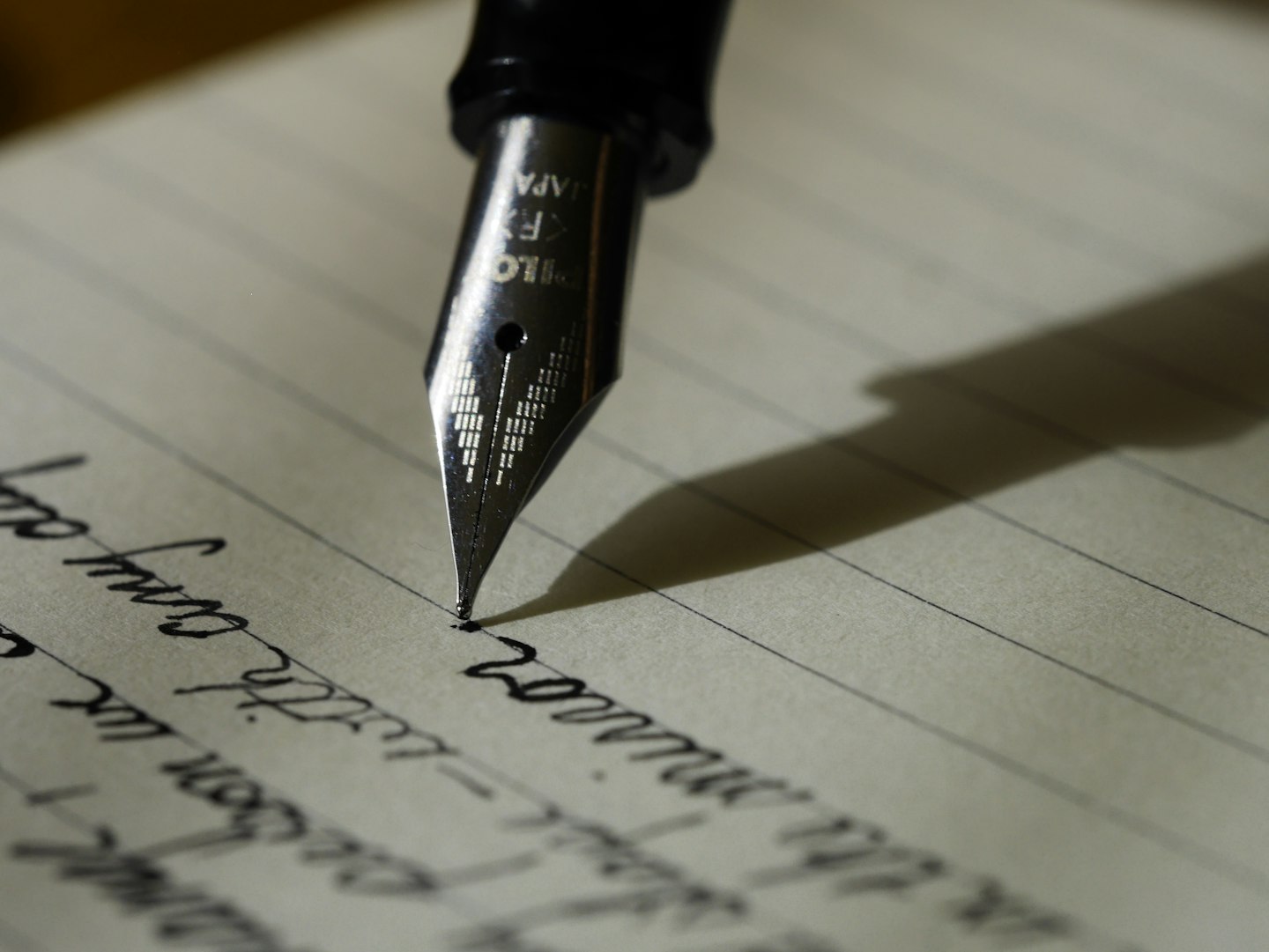 A notebook and pen on a working desk